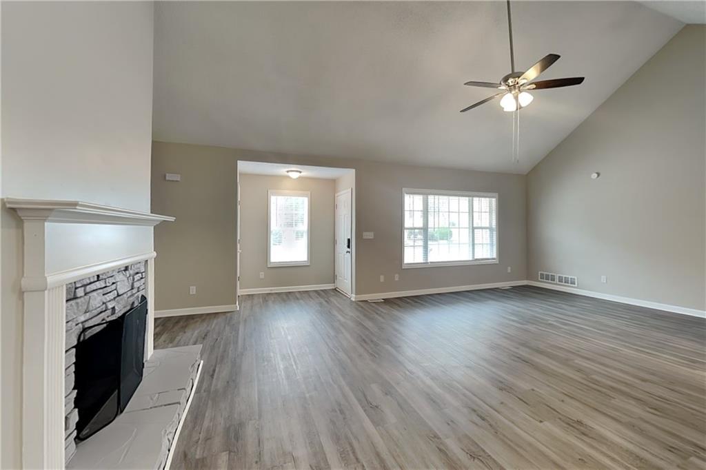 85 Ellen Glen Way Dallas, GA 30132 - Photo 4 of 21 a view of an empty room with wooden floor and a window