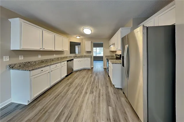 a kitchen with stainless steel appliances a refrigerator sink and stove