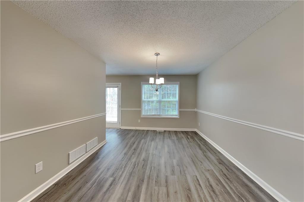 85 Ellen Glen Way Dallas, GA 30132 - Photo 7 of 21 wooden floor in an empty room with a window