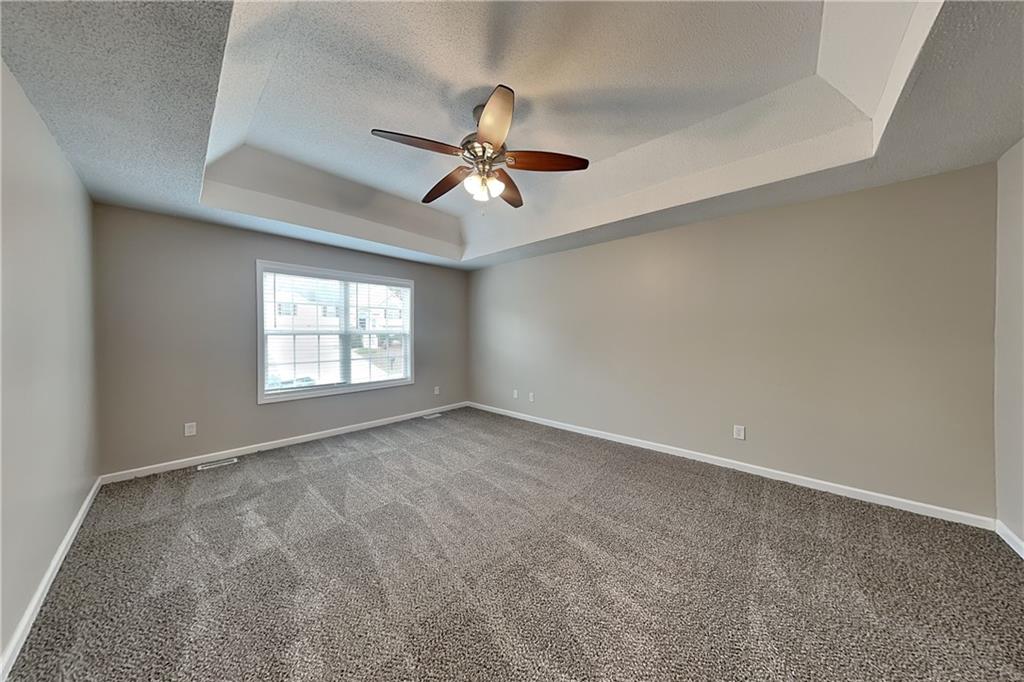 85 Ellen Glen Way Dallas, GA 30132 - Photo 9 of 21 an empty room with windows and fan