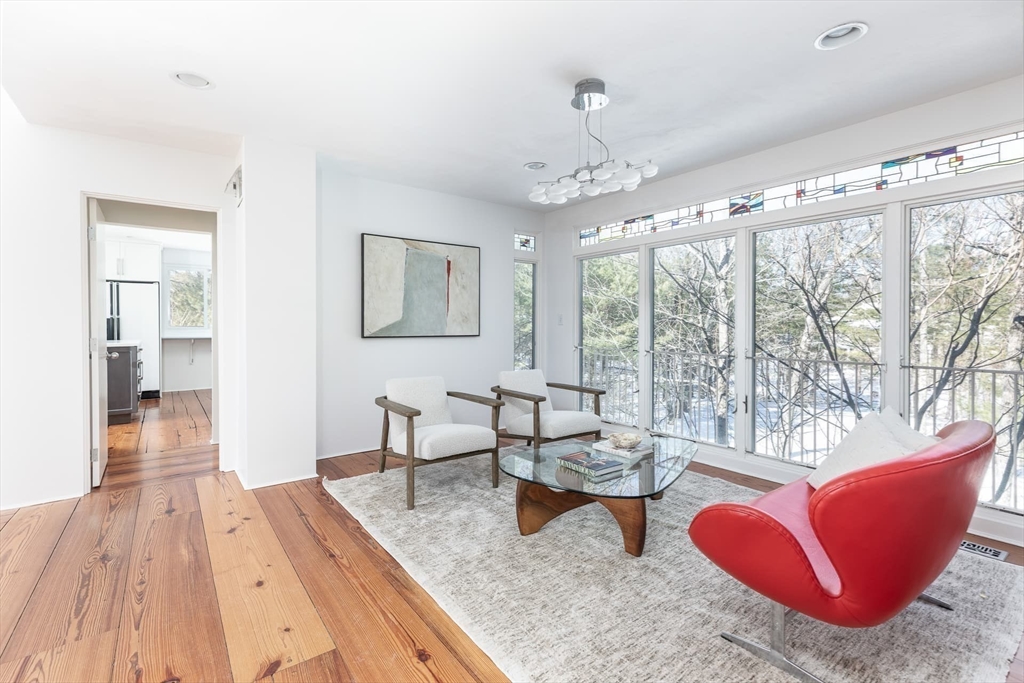 100 Bradford Road Weston, MA 02493 - Photo 17 of 42 a living room with furniture a large window and wooden floor