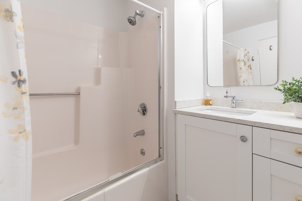 100 Bradford Road Weston, MA 02493 - Photo 30 of 42 a bathroom with a shower sink and mirror