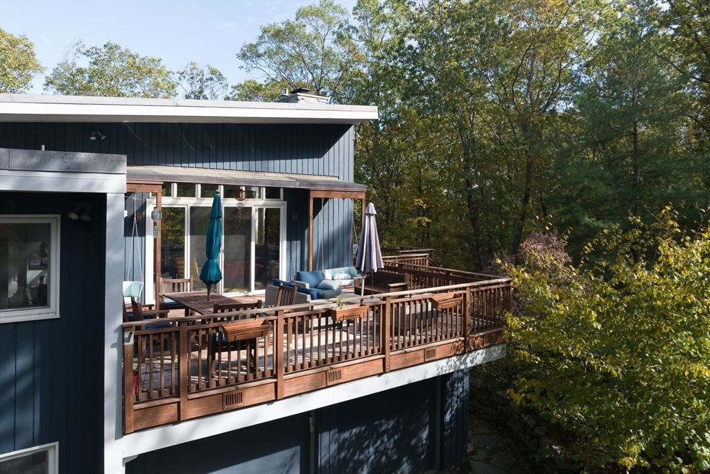 100 Bradford Road Weston, MA 02493 - Photo 3 of 42 a view of house with roof deck and furniture