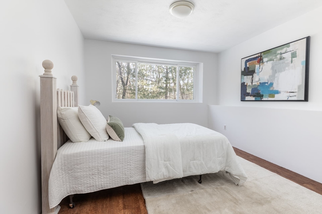 100 Bradford Road Weston, MA 02493 - Photo 31 of 42 a bedroom with a bed and a painting on the wall