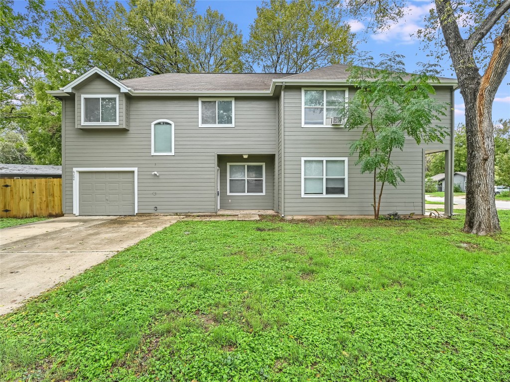 a view of a house with yard and garden