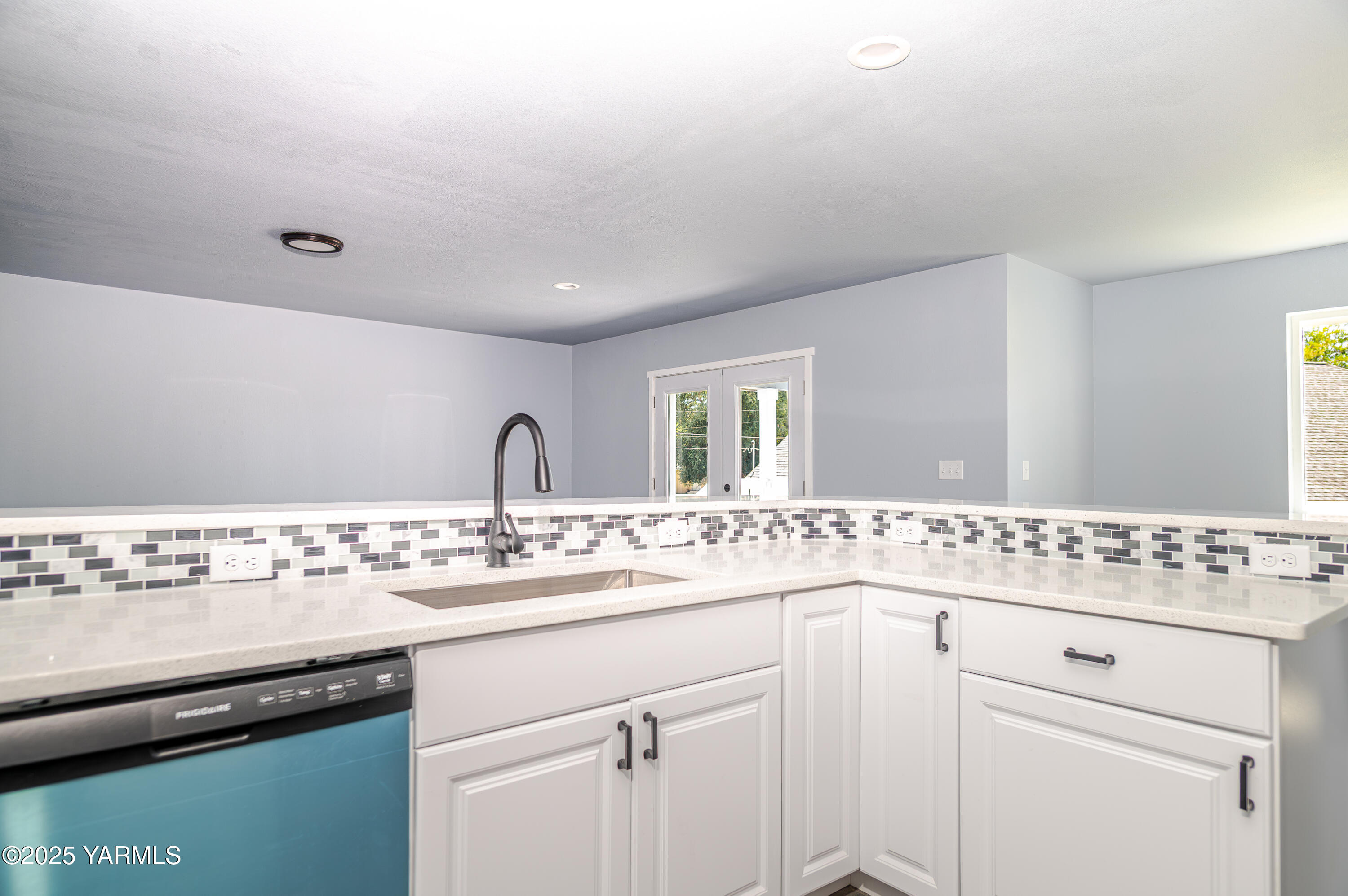213 3rd Street East Granger, WA 98932 - Photo 6 of 12 a view with cabinets a sink and dishwasher