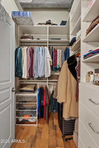 a bed sitting in a bedroom next to a blue wall