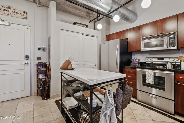 a kitchen with stainless steel appliances granite countertop a sink stove and oven