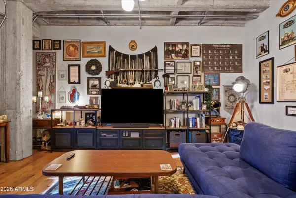 a living room with furniture a flat screen tv and a bookshelf