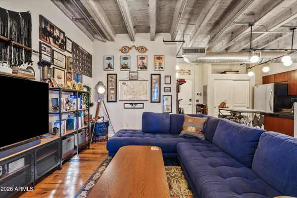 a view of a livingroom with furniture a flat screen tv and a chandelier