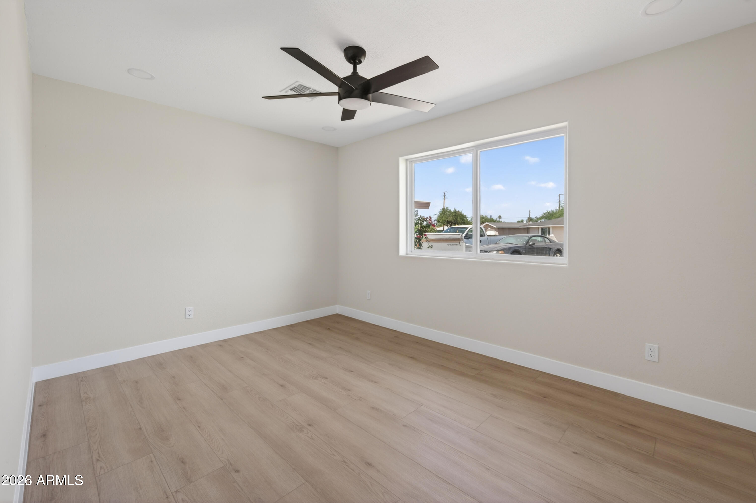 3422 South Terrace Road Tempe, AZ 85282 - Photo 22 of 43 an empty room with wooden floor ceiling fan and windows