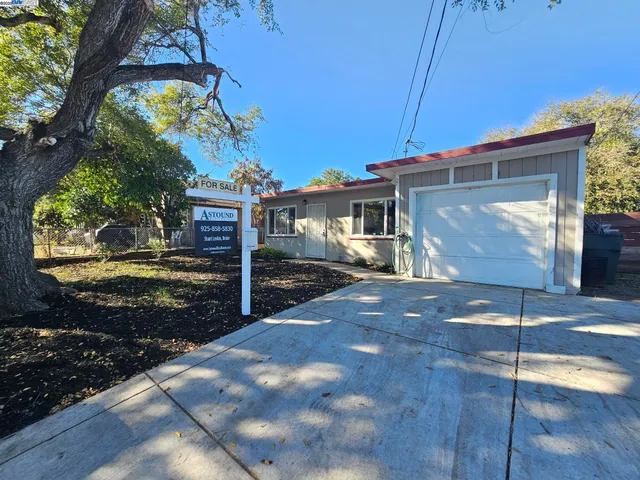 a view of a patio with table and chairs with wooden floor and fence