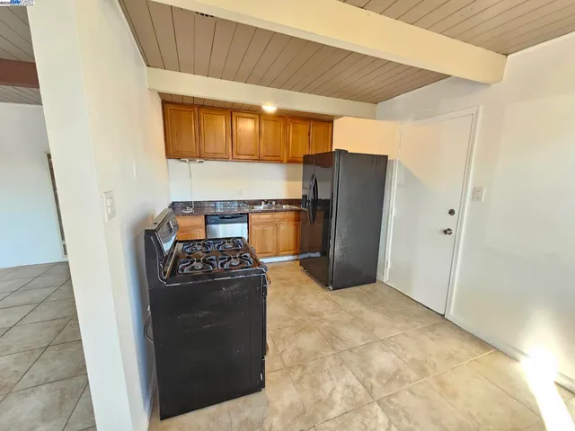 a kitchen with a stove and a refrigerator