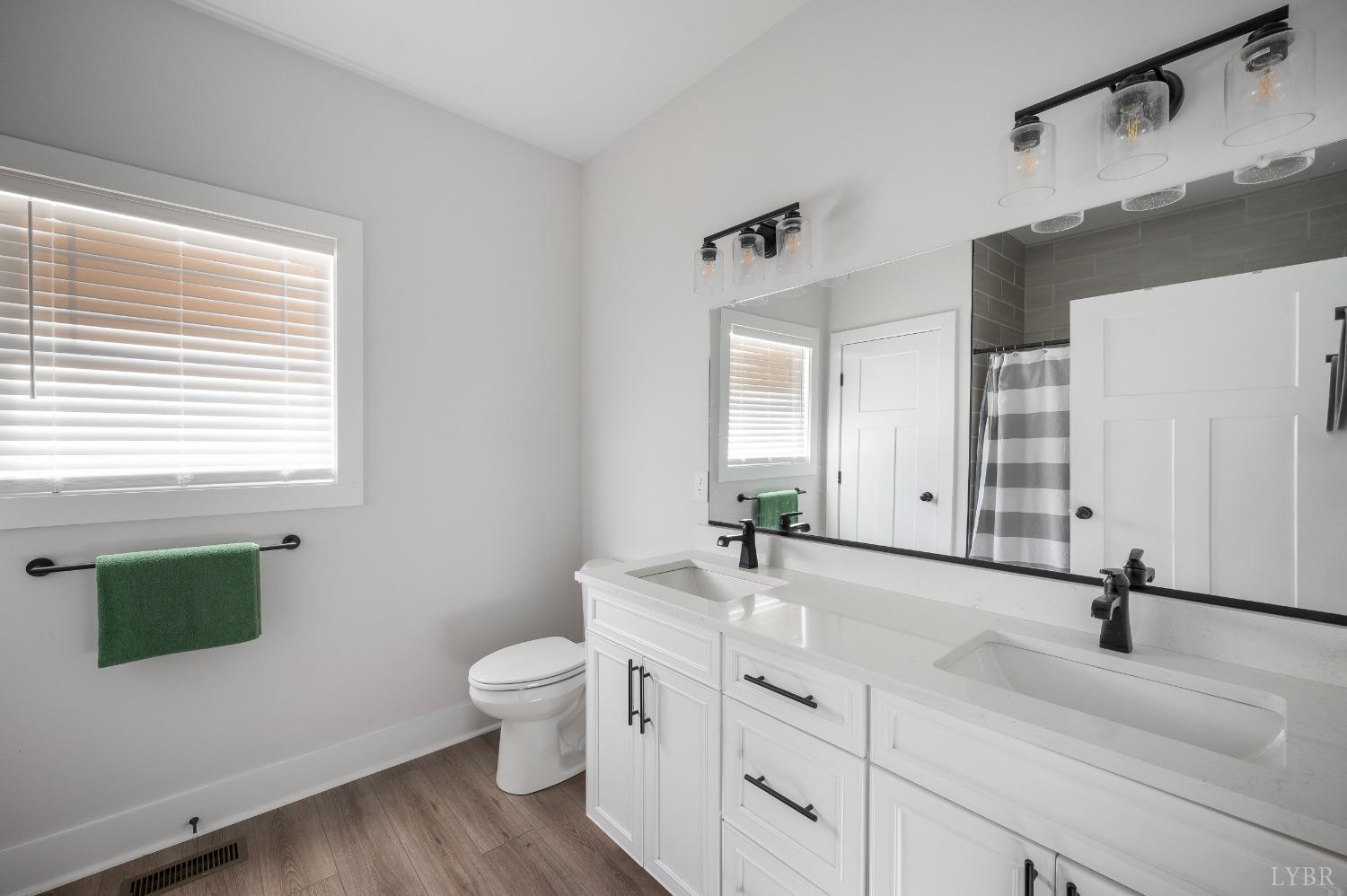 36 Porter Lane Forest, VA 24551 - Photo 11 of 25 a bathroom with a double vanity sink toilet and a mirror