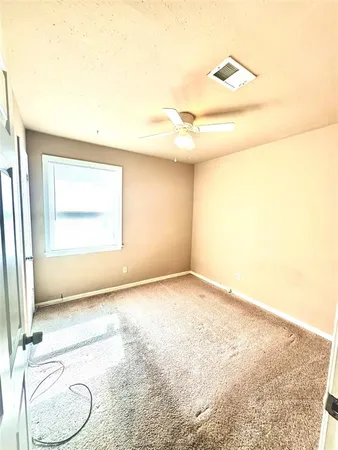 a bathroom with a granite countertop toilet and a sink