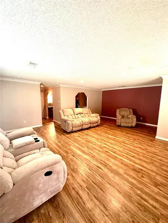 a bedroom with a bed and a lamp on dresser