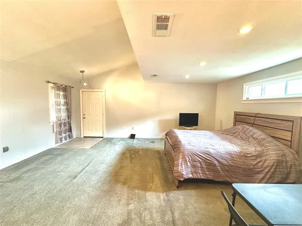 a bedroom with a bed and a couch