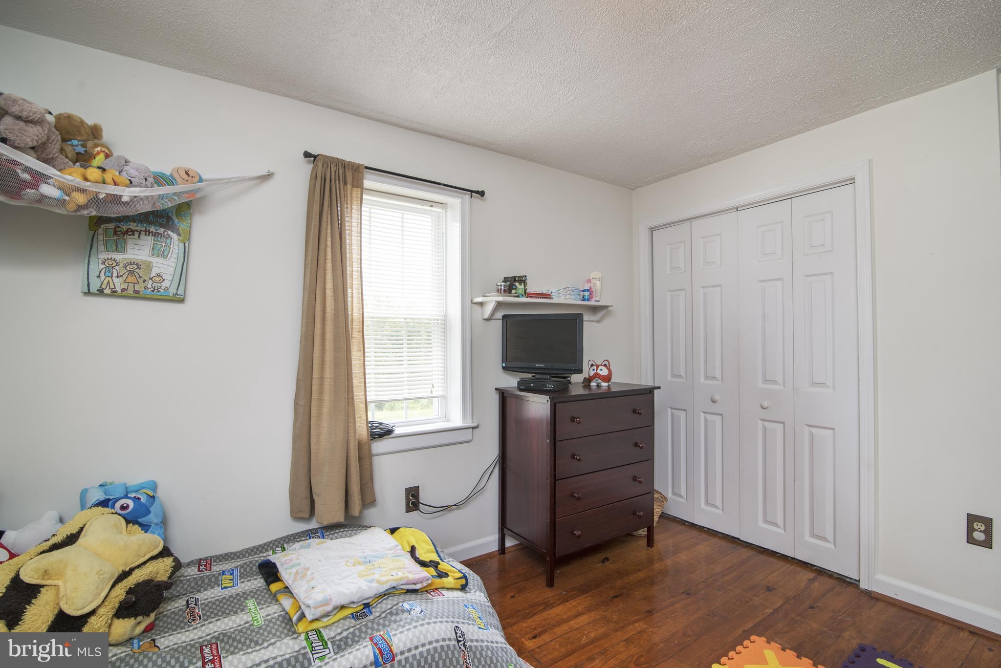 11306 Sword Road Williamsport, MD 21795 - Photo 12 of 30 a bedroom with a bed and wooden floor