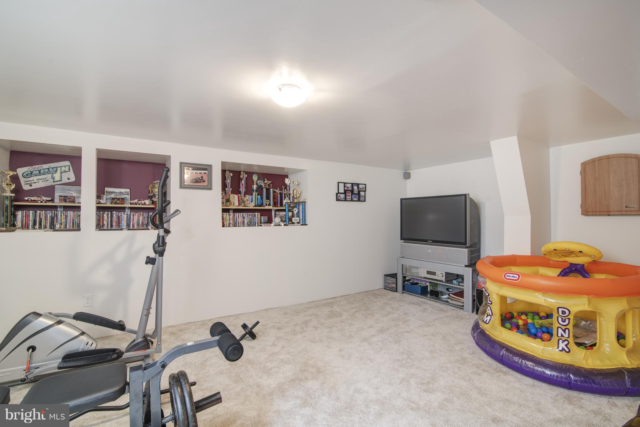 11306 Sword Road Williamsport, MD 21795 - Photo 18 of 30 a bedroom with furniture and a flat screen tv
