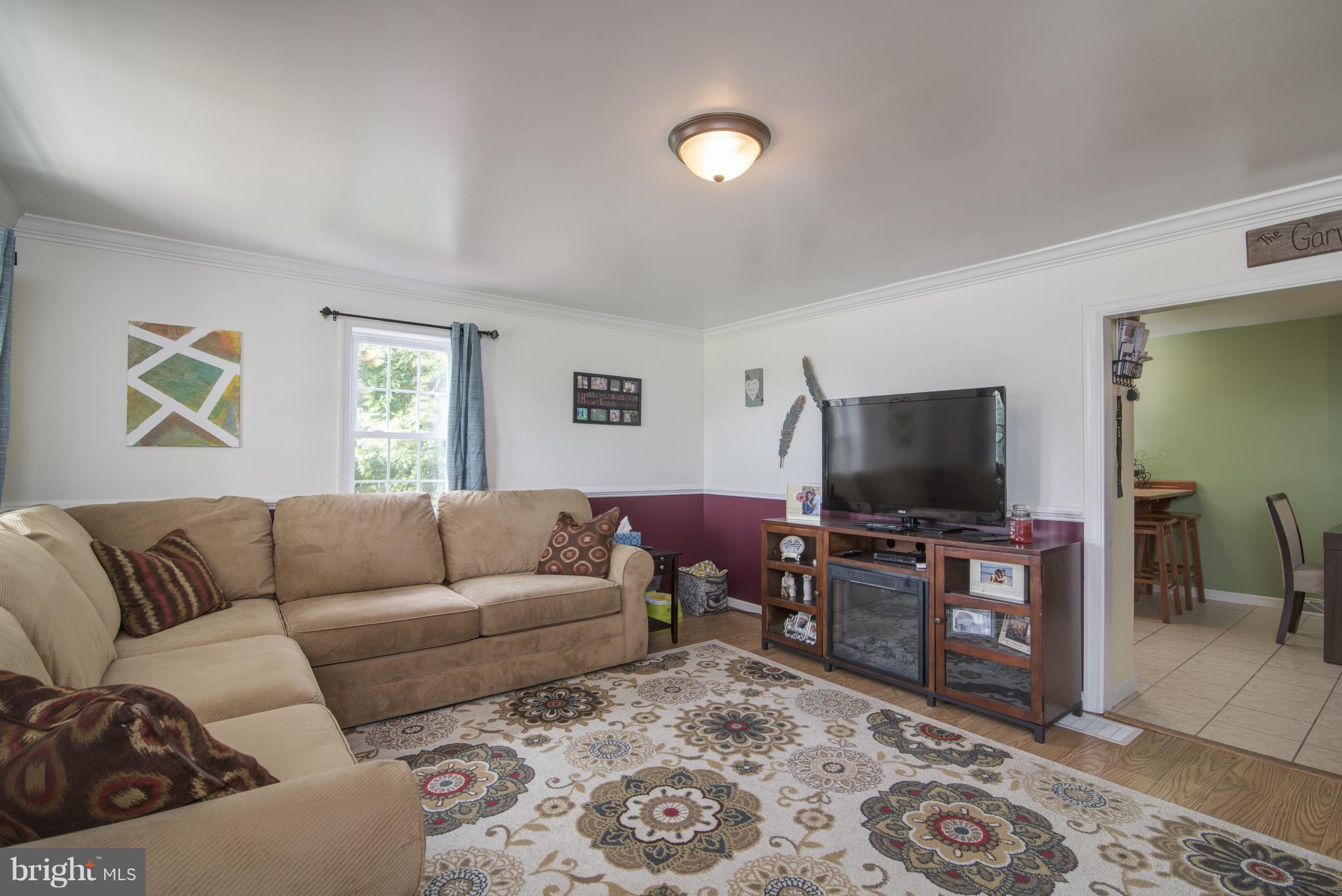 11306 Sword Road Williamsport, MD 21795 - Photo 4 of 30 a living room with furniture and a flat screen tv