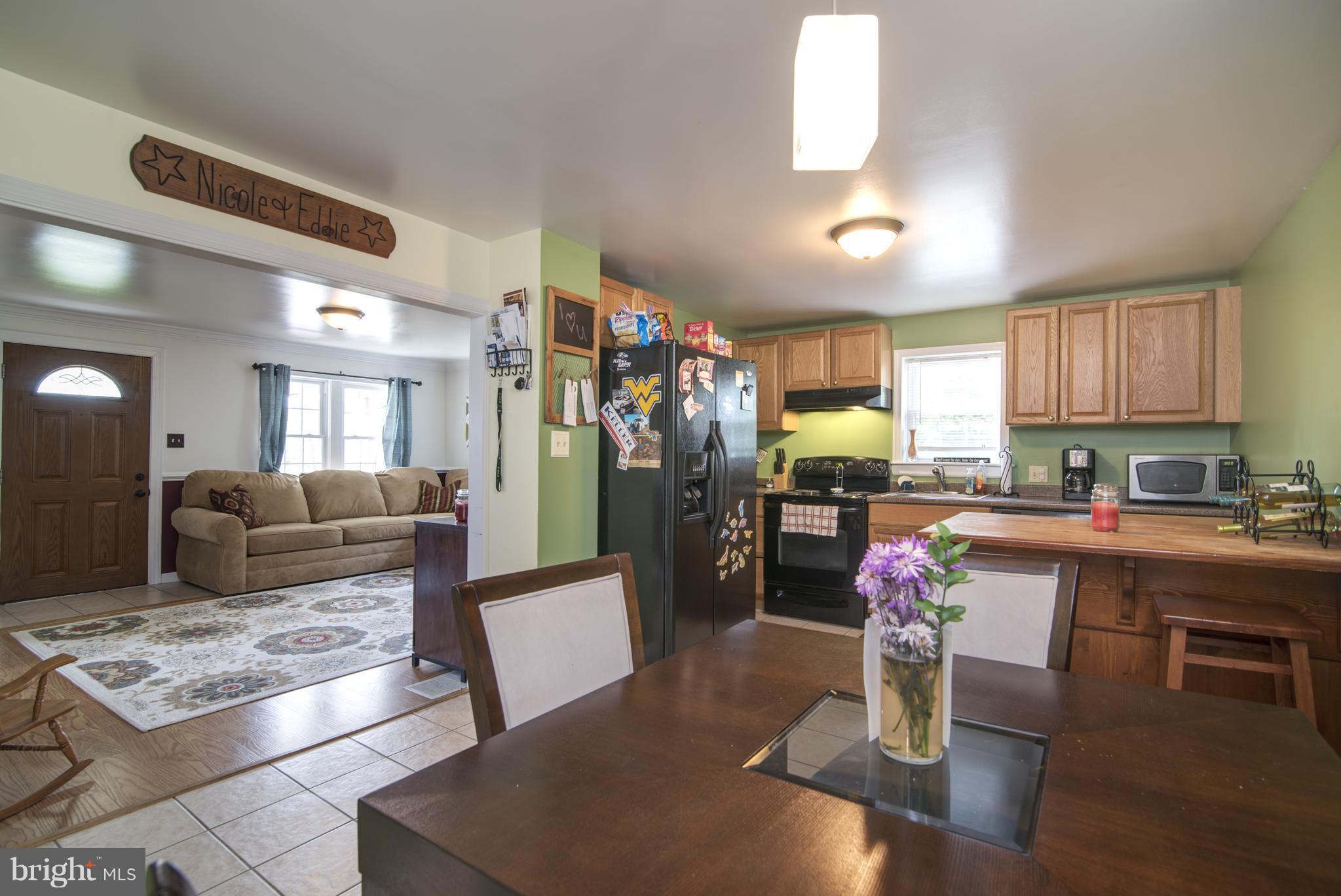 11306 Sword Road Williamsport, MD 21795 - Photo 7 of 30 a living room with granite countertop furniture a rug kitchen view and a window