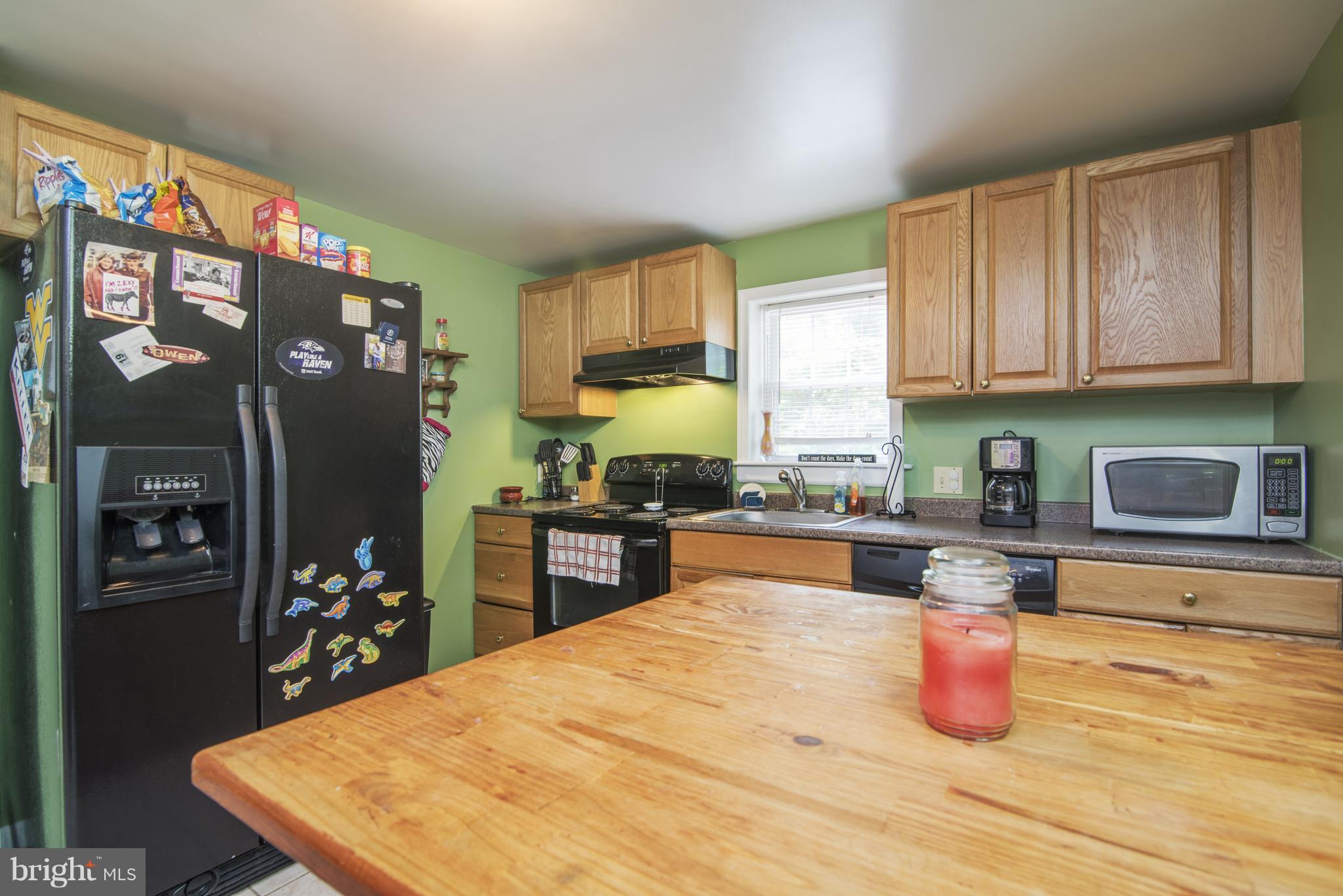 11306 Sword Road Williamsport, MD 21795 - Photo 10 of 30 a kitchen with stainless steel appliances wooden floor and refrigerator
