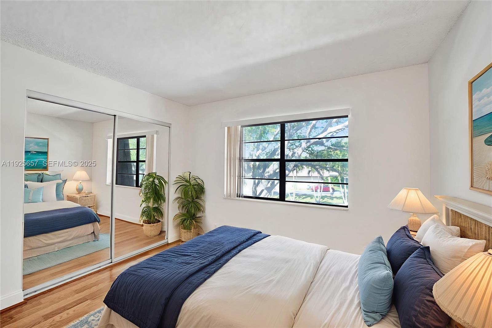 9340 Southwest 61st Way, Unit B Boca Raton, FL 33428 - Photo 16 of 25 a bedroom with a bed and window