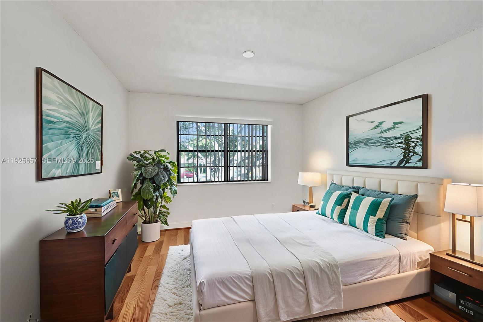 9340 Southwest 61st Way, Unit B Boca Raton, FL 33428 - Photo 19 of 25 a bedroom with a large bed and a potted plant