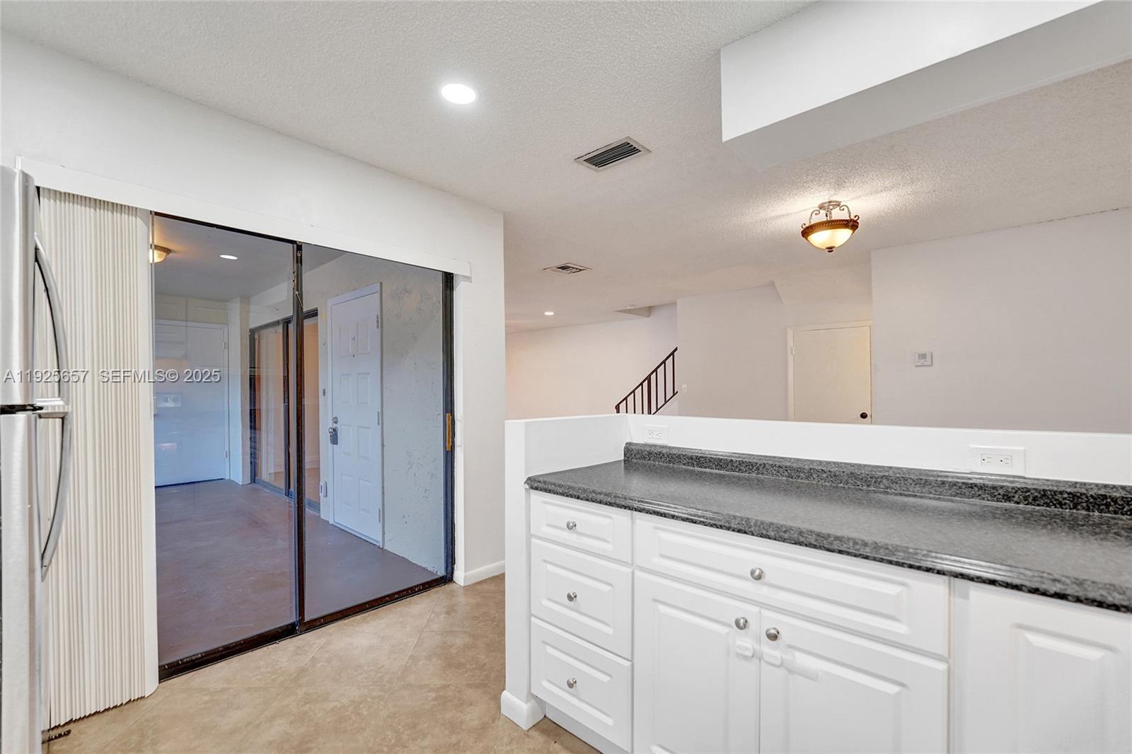 9340 Southwest 61st Way, Unit B Boca Raton, FL 33428 - Photo 8 of 25 a kitchen with a sink and refrigerator