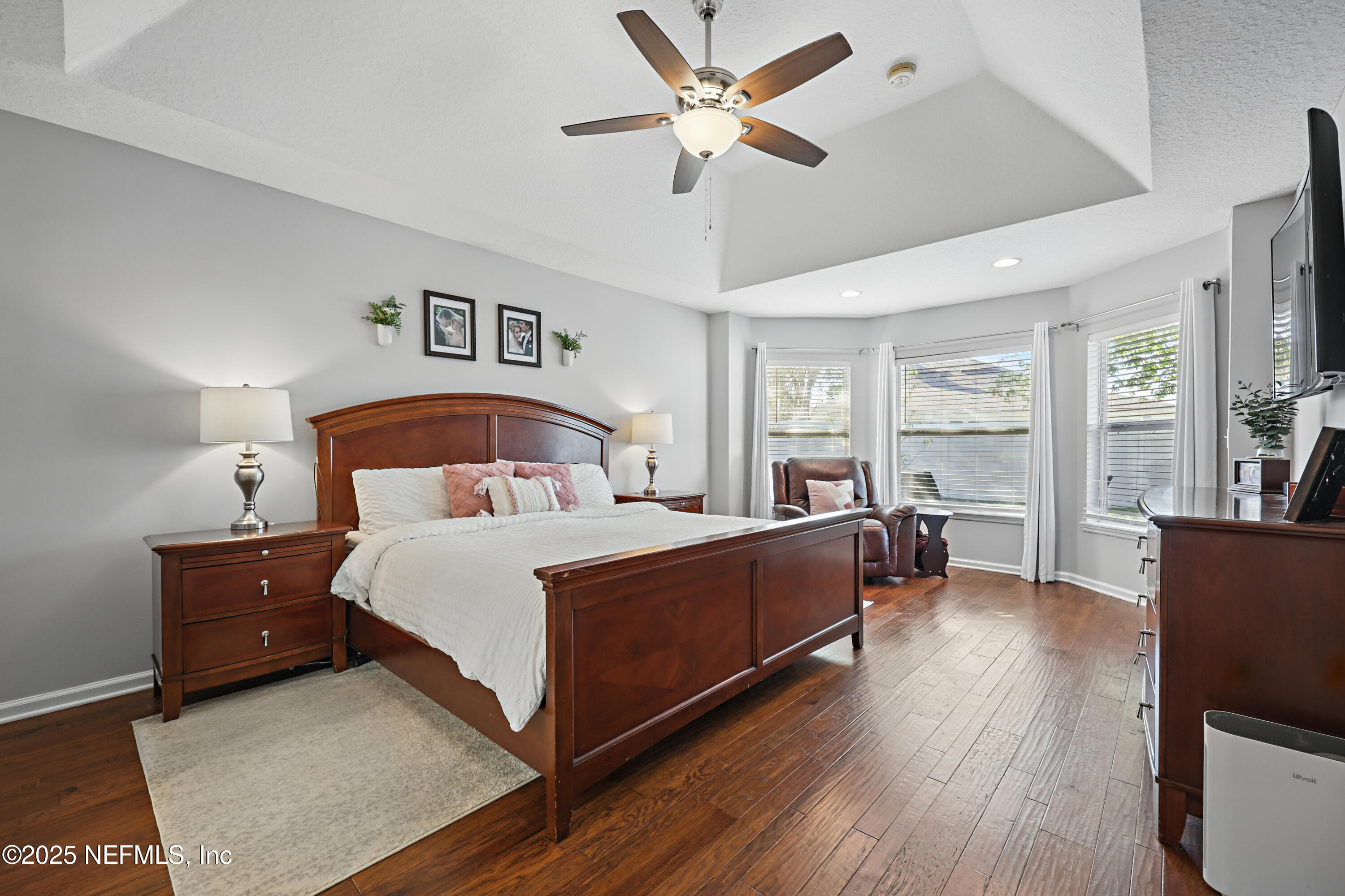 672 Porta Rosa Circle St. Augustine, FL 32092 - Photo 19 of 42 a bedroom with a bed and wooden floor