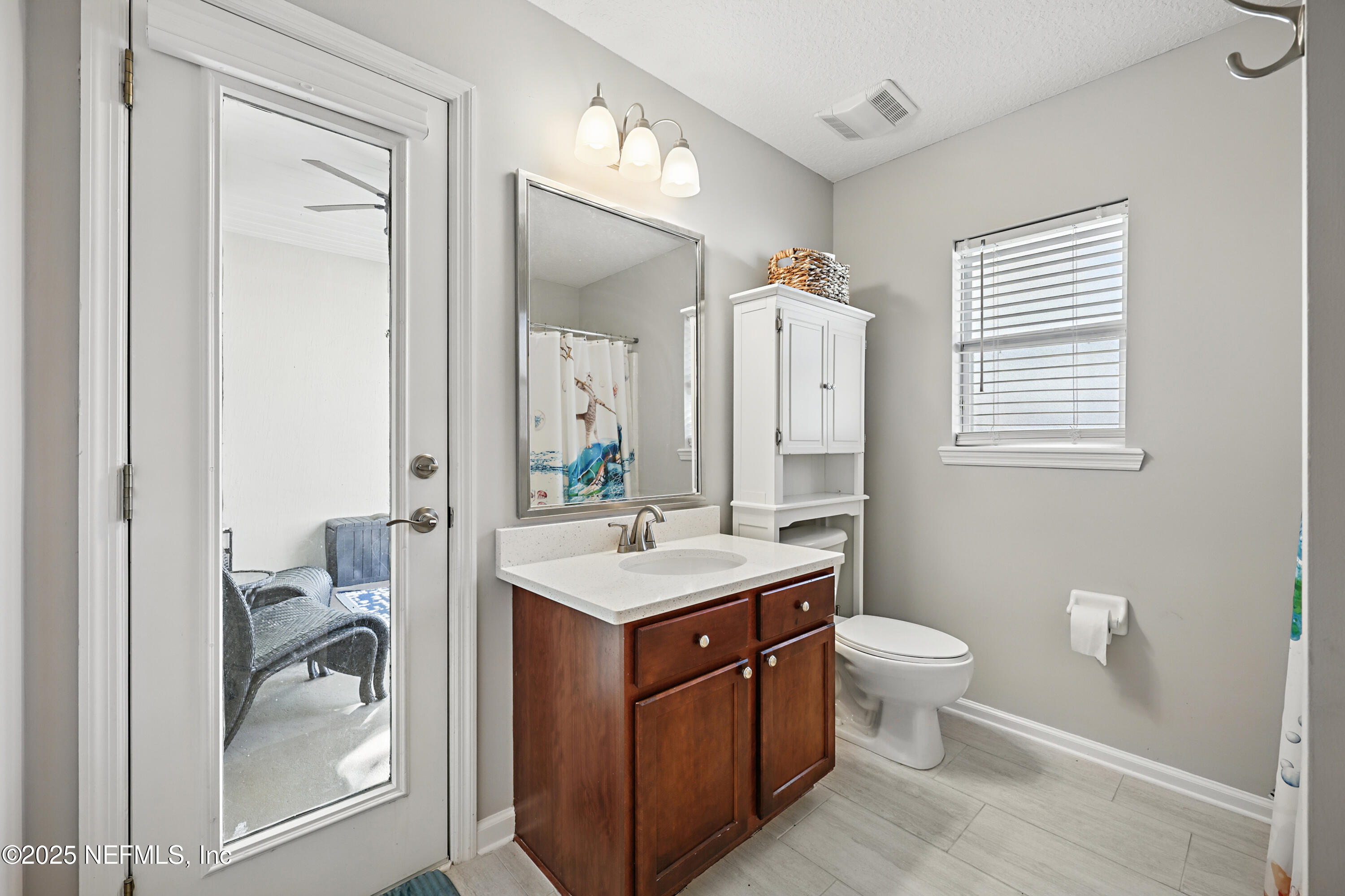 672 Porta Rosa Circle St. Augustine, FL 32092 - Photo 33 of 42 a bathroom with a sink a toilet and a mirror