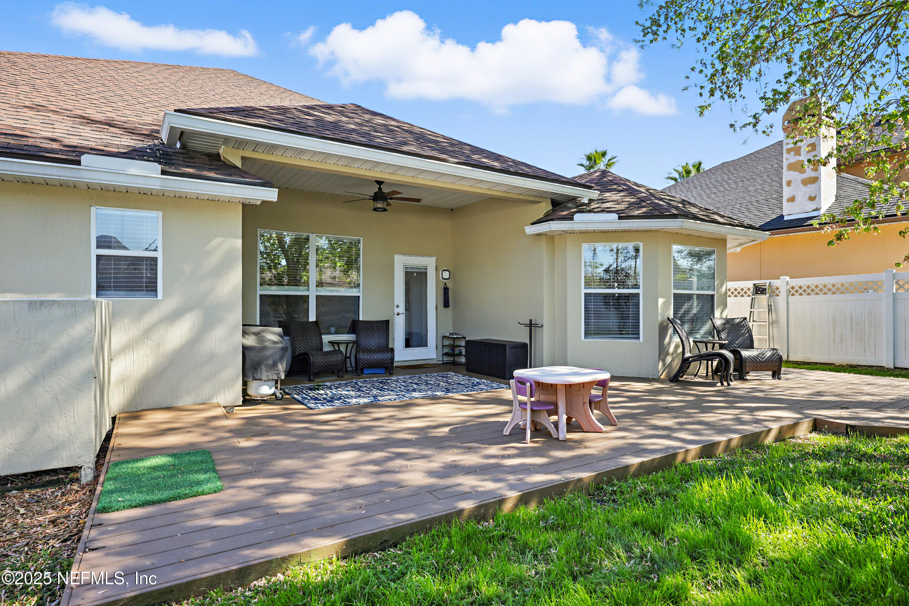 672 Porta Rosa Circle St. Augustine, FL 32092 - Photo 37 of 42 a view of a patio with table and chairs with wooden fence
