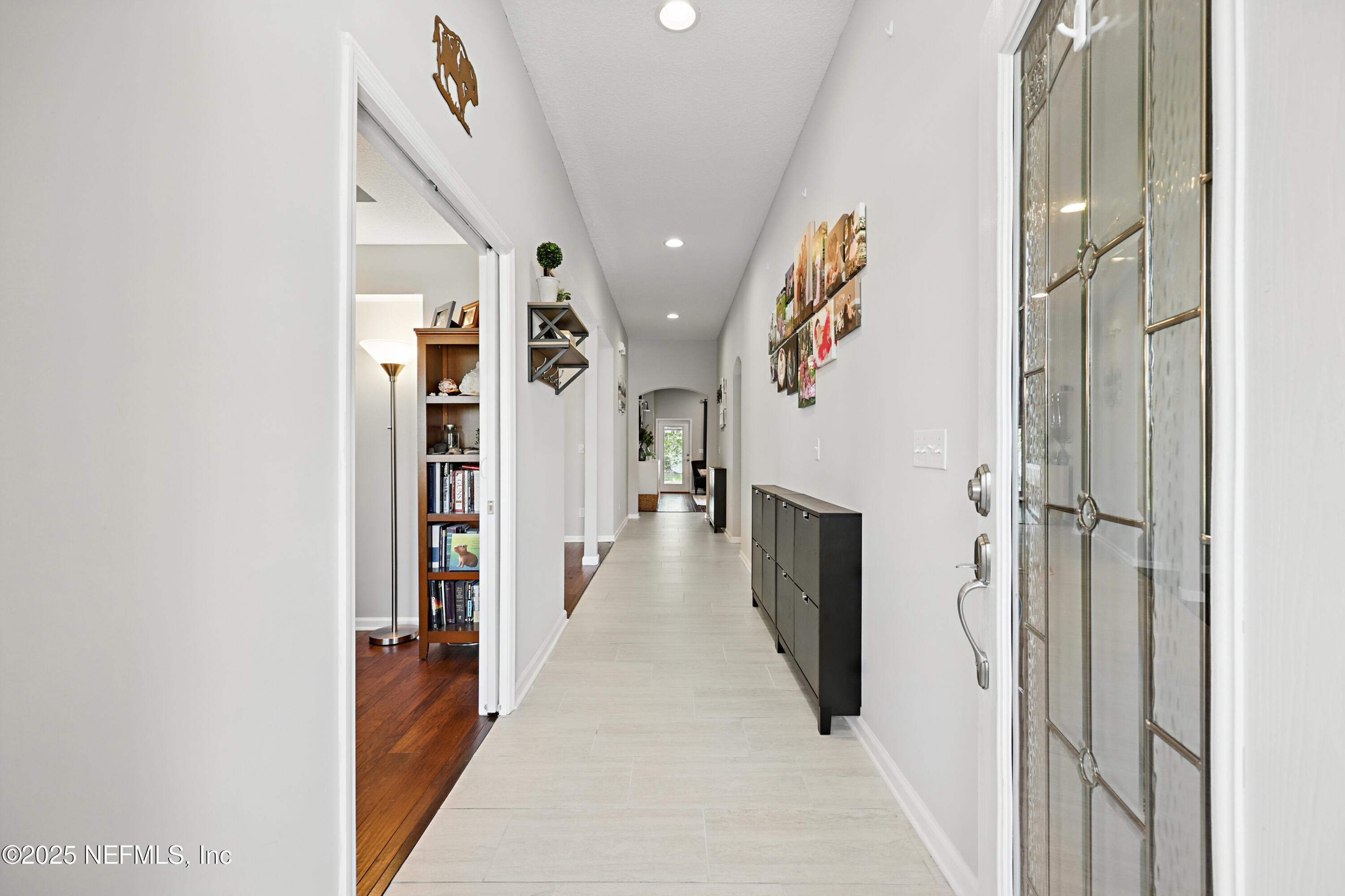 672 Porta Rosa Circle St. Augustine, FL 32092 - Photo 6 of 42 a view of a hallway with wooden floor and staircase