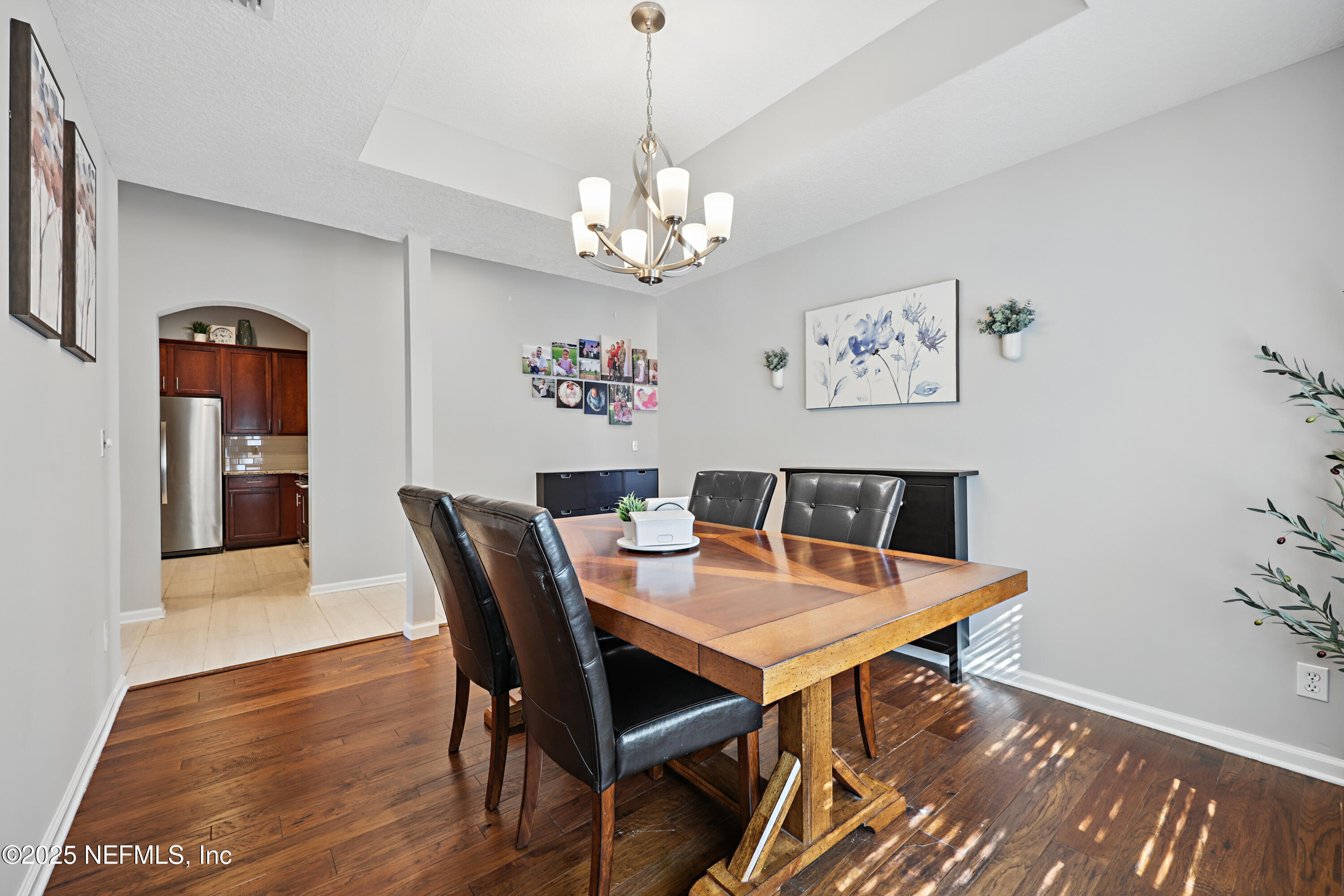 672 Porta Rosa Circle St. Augustine, FL 32092 - Photo 10 of 42 a view of a dining room with furniture wooden floor and a chandelier