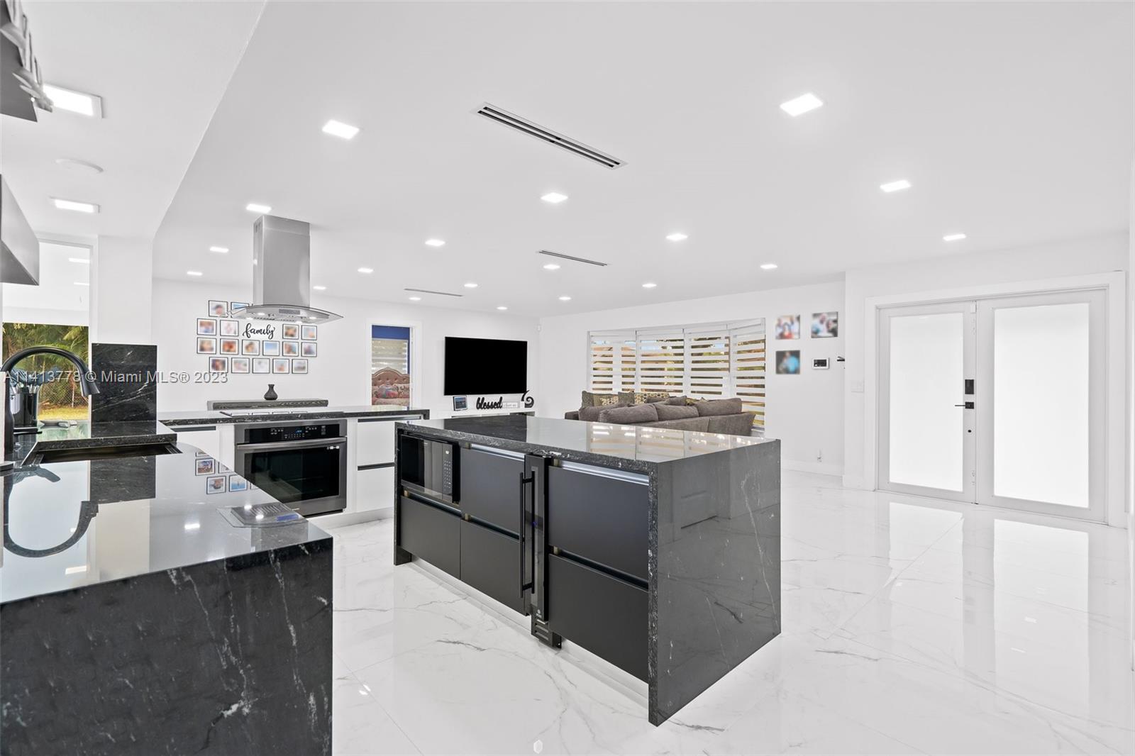 a kitchen with a sink stainless steel appliances furniture cabinets and a counter top space