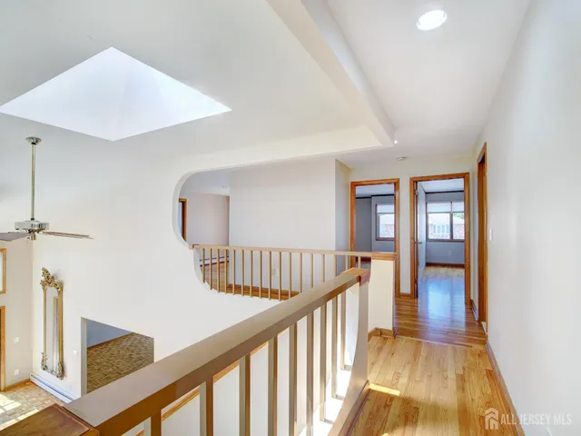 a view of staircase with railing and white walls