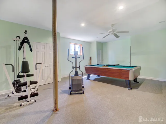 a room with gym equipment and view of living room