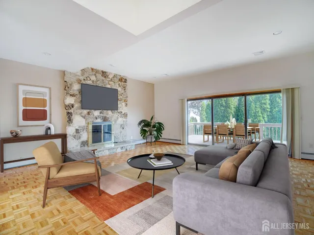 a living room with furniture a flat screen tv and a large window