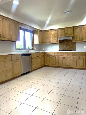 a kitchen with granite countertop a sink cabinets and window