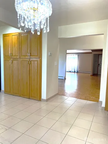 a view of a hallway with a chandelier