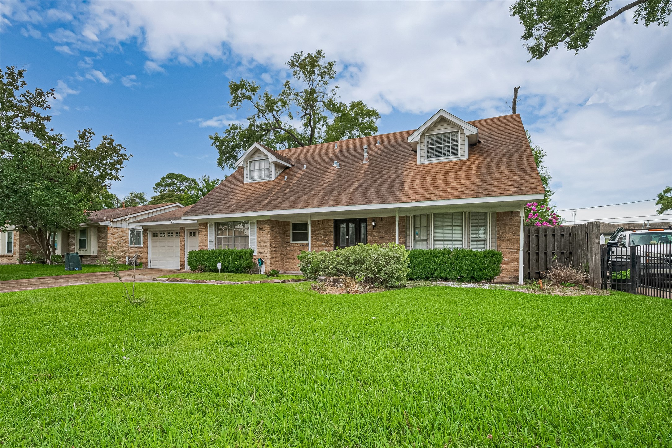 13351 Oak Leaf Lane Houston, TX 77015 - Photo 2 of 27 a front view of a house with a garden