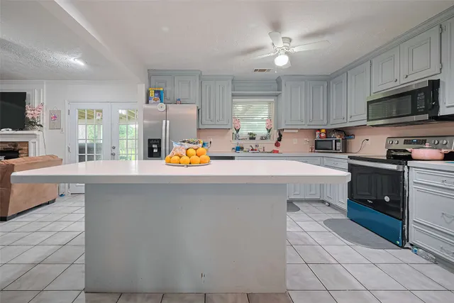 a kitchen with a sink appliances and cabinets