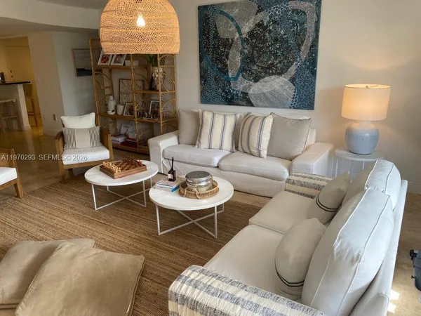 a living room with furniture and a lamp