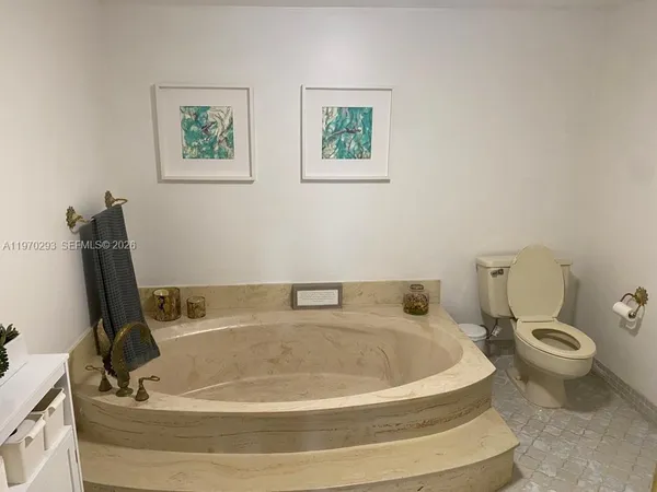 a bath tub sitting next to a white toilet