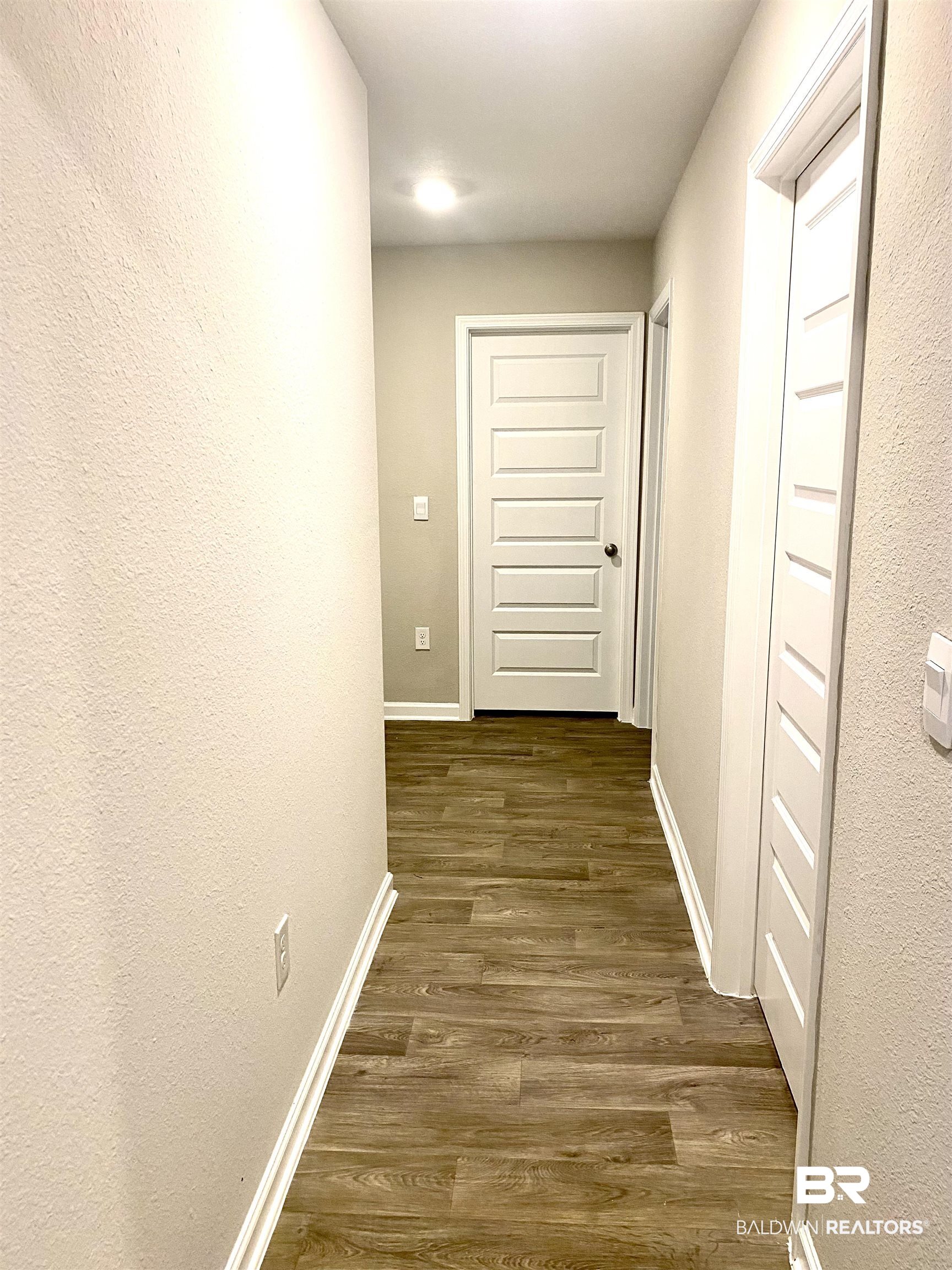 14496 Cavendish Drive Foley, AL 36535 - Photo 12 of 26 Corridor featuring a textured wall and dark wood-style flooring