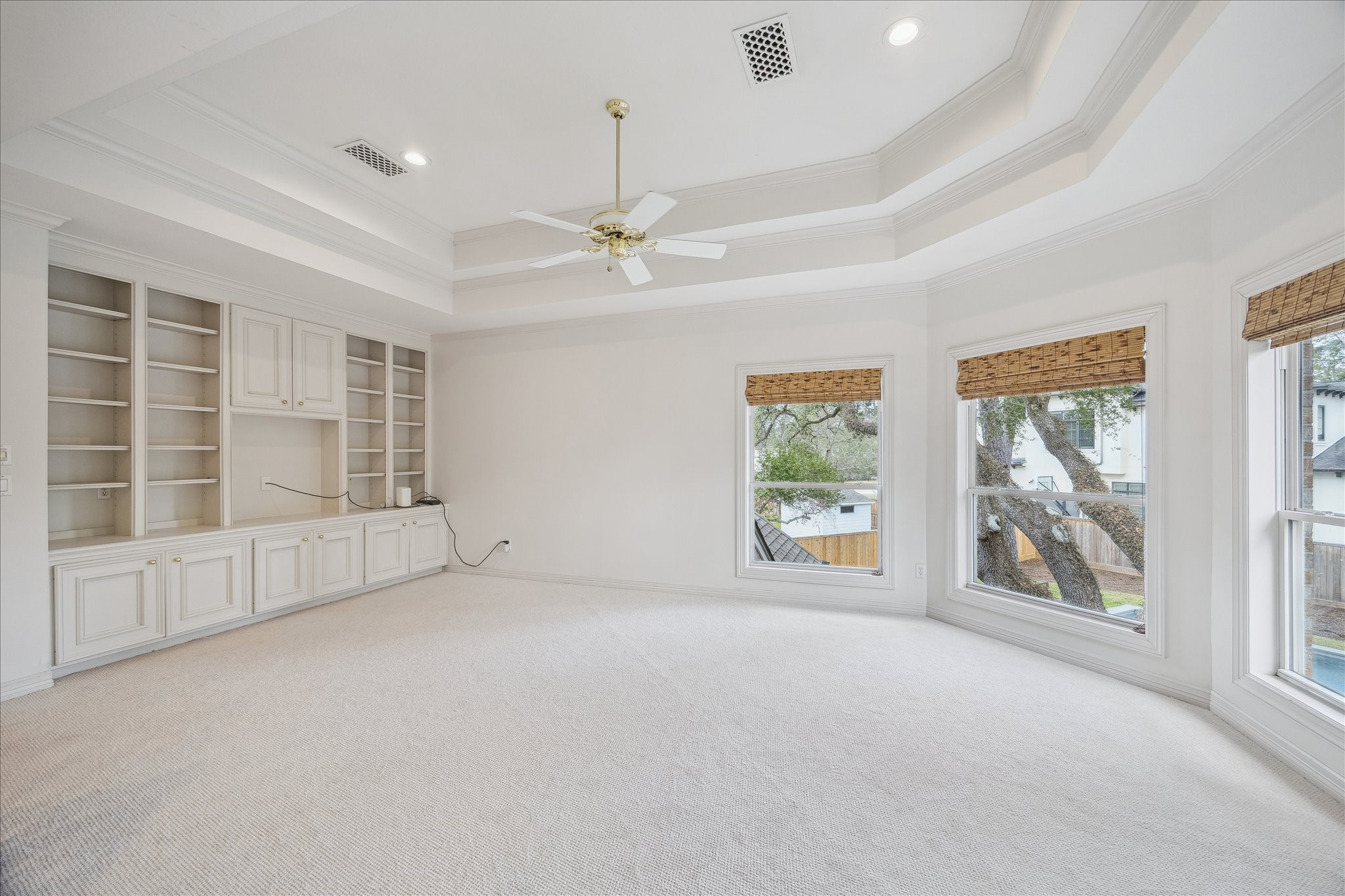 11524 Taylorcrest Road Houston, TX 77024 - Photo 30 of 47 The second-floor game room sits at the top of the stairs and features coffered ceilings, new carpet, a wall of built-in bookshelves and storage, and beautiful views of the backyard.