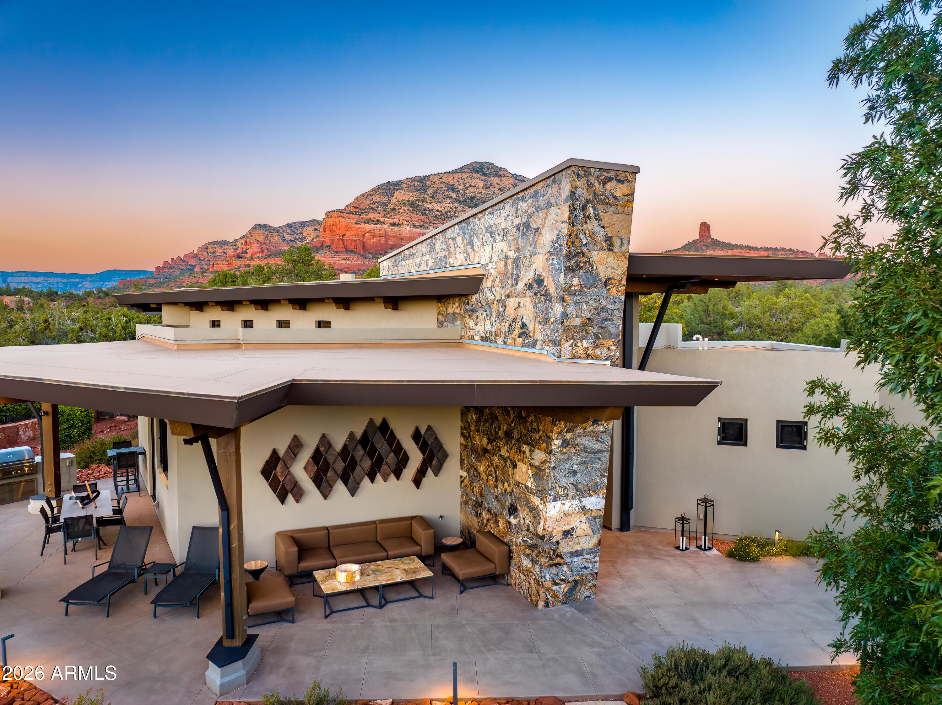 120 Paisano Road Sedona, AZ 86336 - Photo 3 of 52 a view of a patio with a table and chairs under an umbrella