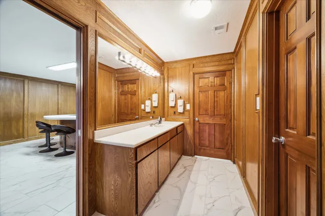 a large white bed in a balcony next to a window