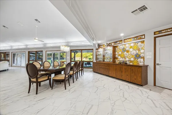 a dining room with furniture water view and balcony