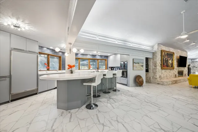 a large white kitchen with a large window